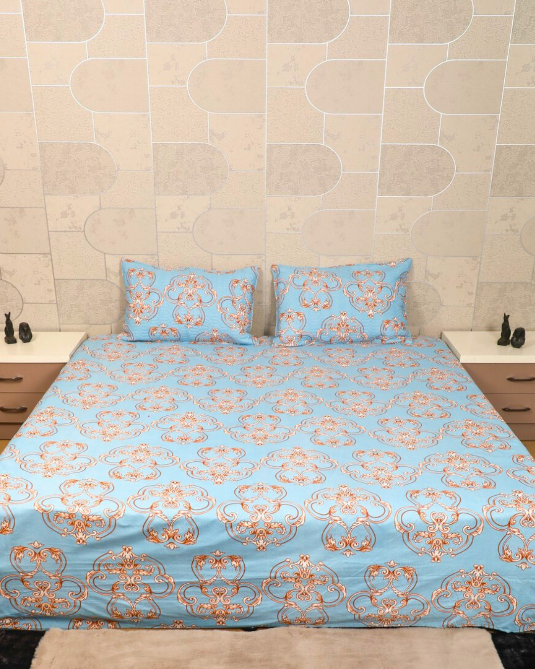 Blue king size bedsheet with intricate royal motifs and matching quilted pillow cover close up