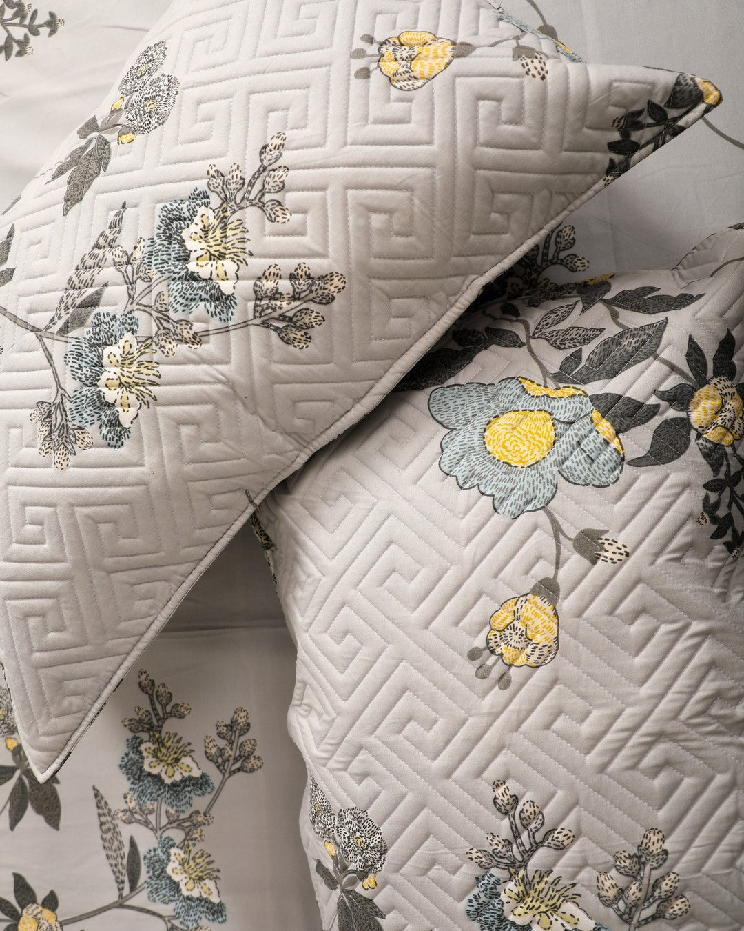 gray with floral print king size bedsheet with close up of quilted pillow cover